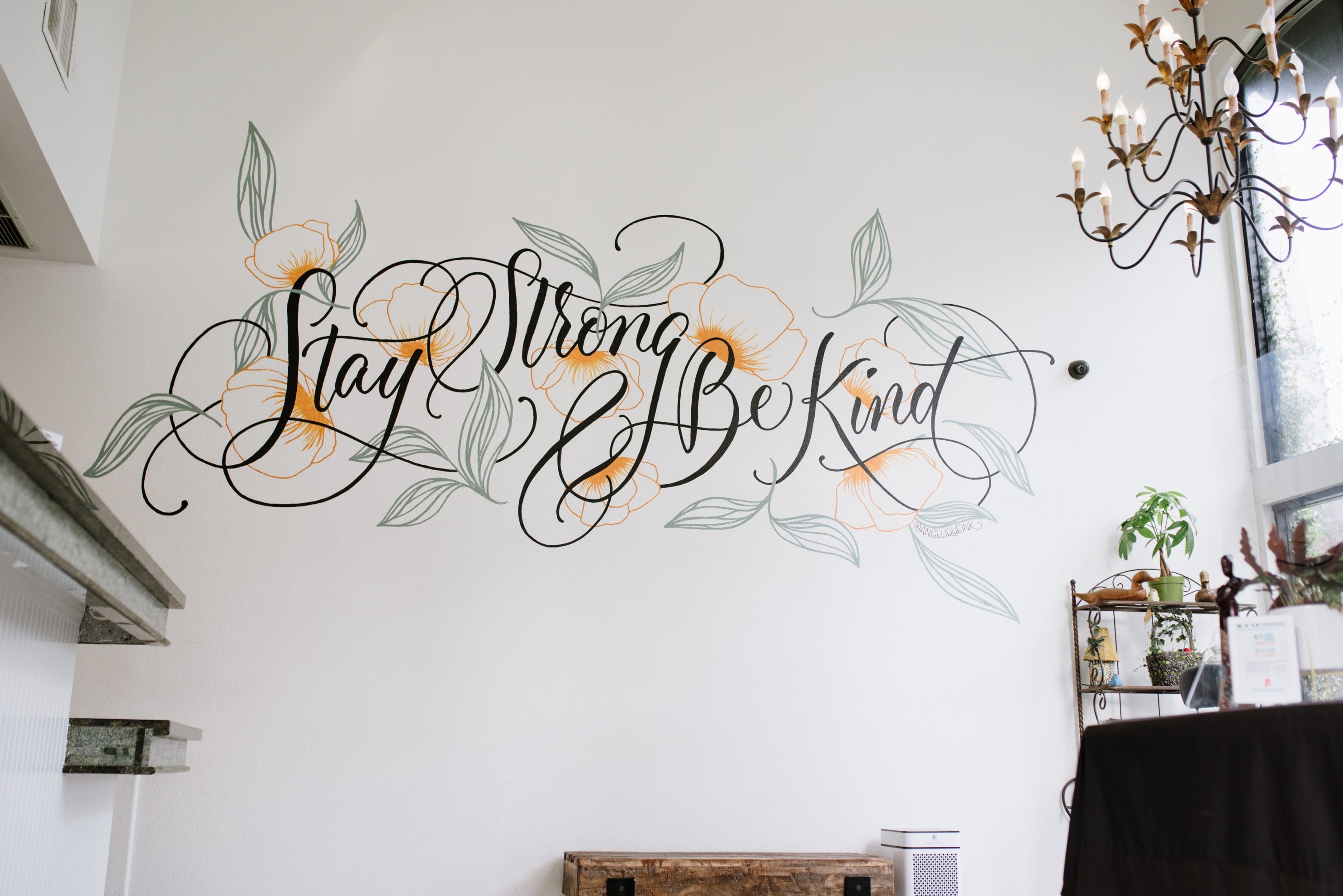a lobby wall with a mural that reads 'Stay Strong Be Kind'
